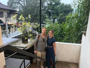 a man and a woman standing on the stairs of a house at Tenshin Residance. in Kandy