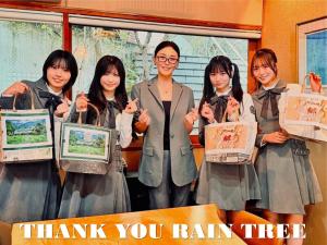 a group of women holding framed art in a classroom at ホテル郷 in Uda