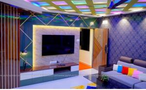 a living room with a couch and a flat screen tv at SIS Acropole in Golden Rock