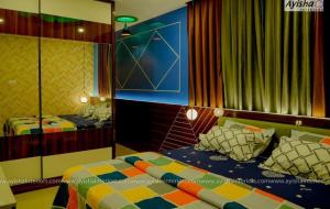 a bedroom with two beds and a mirror at SIS Acropole in Golden Rock