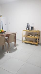 a table and chairs in a room with a white floor at Villas do paraíso brisa in Marau