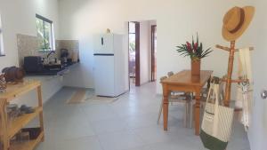 a kitchen with a white refrigerator and a table at Villas do paraíso brisa in Marau +16 photos