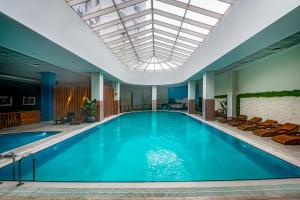 a pool in a hotel with a ceiling at Sky-High 1BR 30 Floor Spa,Gym Cevahir Tower A in Skopje
