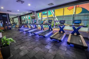 a gym with rows of tread machines in a building at Sky-High 1BR 30 Floor Spa,Gym Cevahir Tower A in Skopje
