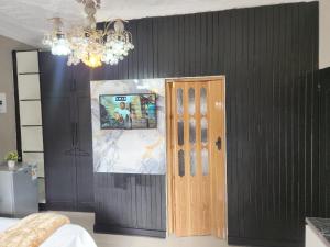 a bedroom with a door and a chandelier at WinHaven Guest House in Randfontein