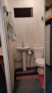 a bathroom with a toilet and a sink at Cabana Candeia in Palmeiras +7 photos