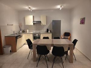 a kitchen with a table and chairs in a room at Maison Pero in Supetar