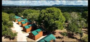 an overhead view of a group of houses with trees at Texas State Glamping in this Charming Cabin Rental for Six in Pipe Creek in Pipe Creek