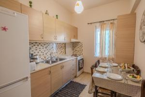 a kitchen with a table and a dining room at Georgias Apartments in Haraki