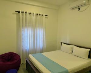 a small bedroom with a bed and a window at The Lotus House - Ahangama in Ahangama +36 photos