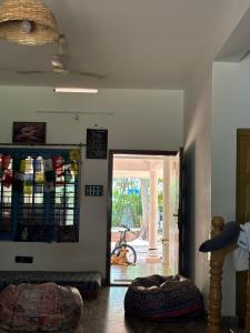 a room with a door leading to a patio with a bike at Barefoot Hostels, Varkala in Varkala