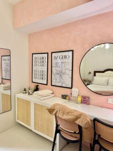 a dressing room with a desk and a mirror at Suite Escapes Brenthill Baguio 1 Bedroom in Baguio