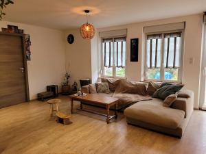 a living room with a couch and a table at Gîte cosy dans les Vosges in Rochesson