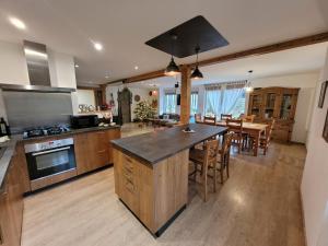 a large kitchen with a large island in the middle at Gîte cosy dans les Vosges in Rochesson