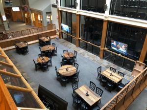 an overhead view of a restaurant with tables and chairs at Modern Condo with Ski In & Ski Out - Silver Creek Lodge, Snowshoe in Snowshoe