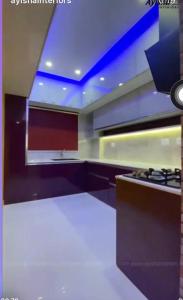 a large kitchen with a stove at SIS Acropole in Golden Rock