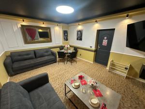 a living room with a couch and a table at Courtyard Central Premium Apartment in Craiova