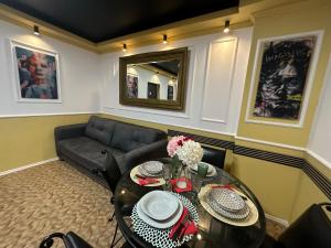 a living room with a table and a couch at Courtyard Central Premium Apartment in Craiova +33 photos