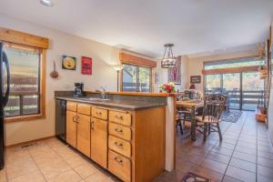 a kitchen with a sink and a dining room at RMR: Primrose 1711 Condo in The AspensWilsonWY in Wilson +13 photos
