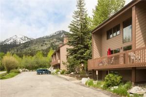 a car parked in a parking lot next to a building at RMR: Wind River 4 Condo in Teton Village in Teton Village