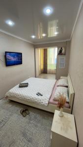 a bedroom with a bed in a room with a table at Первая береговая линия in Aktau +28 photos