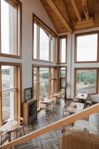 Zimmer mit Tischen, Stühlen und Fenstern in der Unterkunft Wyndham Residences Aqkol in Aqköl