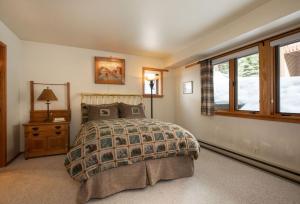 a bedroom with a bed and a window at RMR: Wind River 10 Condo in Teton Village in Teton Village