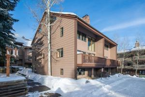 a building with snow in front of it at RMR: Wind River 15 Condo in Teton Village in Teton Village