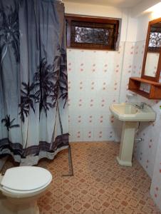 a bathroom with a toilet and a sink at Villa Onus in Aluthgama