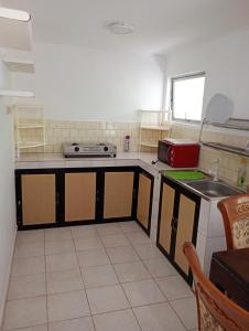 a kitchen with a stove and a sink in it at Villa Onus in Aluthgama +13 photos