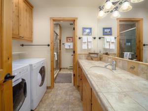 a bathroom with a sink and a washing machine at RMR: Strawberry 3922 Condo in The AspensWilsonWY in Wilson +14 photos