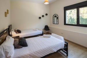 a bedroom with two beds and a window at Beautiful house 15 min away from Bilbao in Llodio