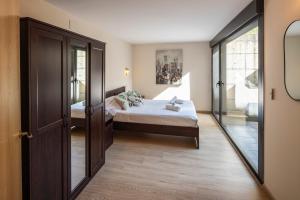 a bedroom with a bed and a sliding glass door at Beautiful house 15 min away from Bilbao in Llodio