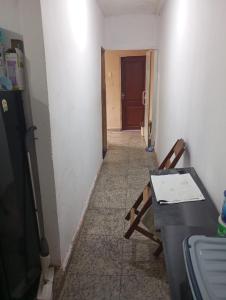 a hallway with a table and a desk in a room at Cop 30 in Belém