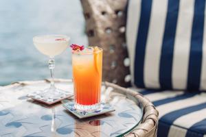 a table with two drinks on top of a table at Eden Roc Marina Hotel in Ascona +19 photos