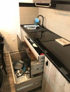 a kitchen with a sink and a counter top at Apartman broj 19 in Banja Koviljača +5 photos