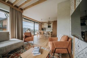 a living room with a couch and chairs and a table at Matygowa Osada in Gliczarów Górny
