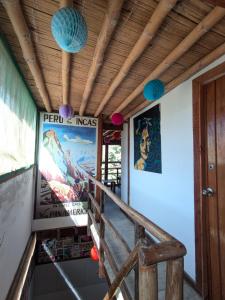 a porch with a wooden ceiling and some lights at Máncora Hostel Restocafebar in Máncora +18 photos