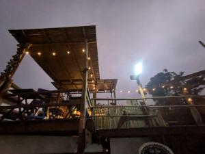 a night view of a deck with a light on it at Máncora Hostel Restocafebar in Máncora