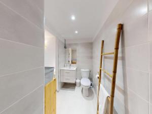 a small bathroom with a toilet and a sink at Anoli Studio Location in Les Trois-Îlets