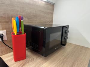 a red cup with pens in front of a microwave at LeLafayette in Metz +4 photos