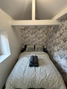 a bed with a pair of shoes sitting on it at LeLafayette in Metz