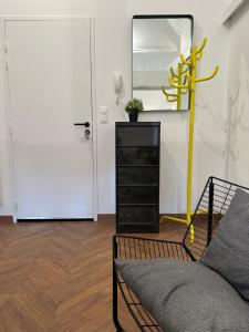 a living room with a mirror and a couch and a dresser at LeLafayette in Metz