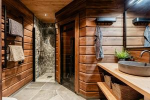 a bathroom with a sink and wooden walls at Mountain Lodge With Views Over Idre in Idre +32 photos