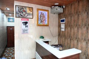 a lobby with a cash counter and signs on the wall at Hotel Bhagirath in Mumbai
