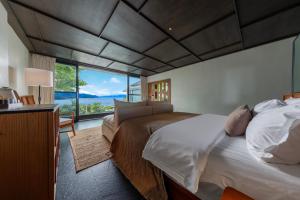 a bedroom with two beds and a large window at Dali Lanting Seaview Hotel in Dali