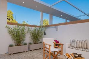 a room with plants in pots on the wall at Suncourt Lux Rooms in Laganas