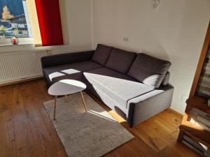 a living room with a couch and a table at Ferienwohnung Lackner in Niedernsill +13 photos