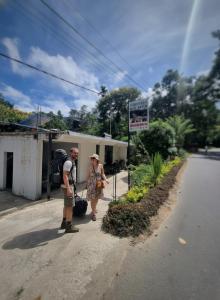a man and a woman walking down the street at Ella Mist Haven in Ella