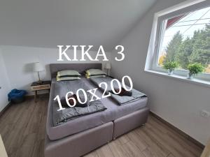 a bedroom with a bed with a sign that reads kka at Kika apartmani-FREE PARKING- 7 km od centra in Zagreb